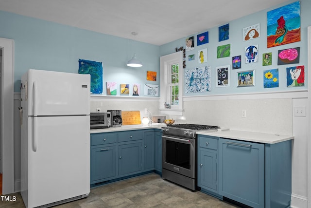 kitchen with tasteful backsplash, white refrigerator, gas stove, light tile floors, and blue cabinets