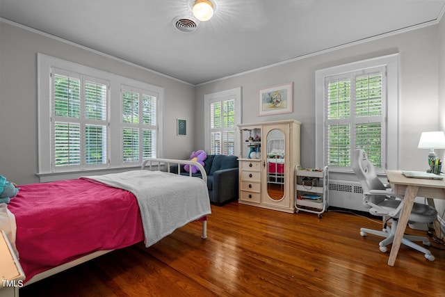 bedroom featuring radiator, ornamental molding, and dark hardwood / wood-style floors