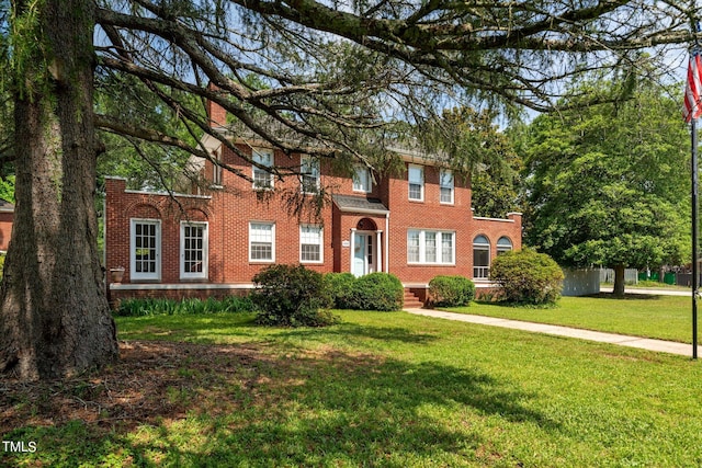 colonial home with a front lawn