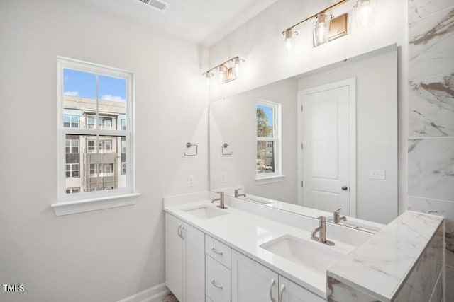 bathroom featuring vanity and a healthy amount of sunlight