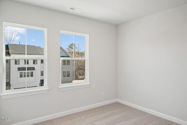 spare room with carpet flooring and plenty of natural light