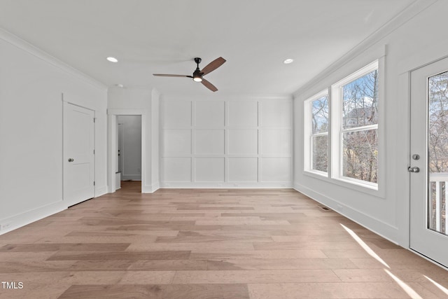 spare room with crown molding, light hardwood / wood-style floors, and ceiling fan