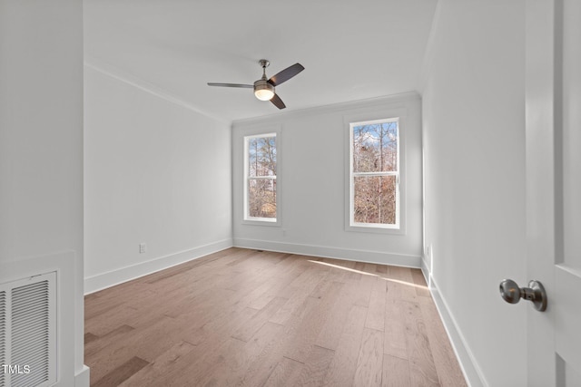 spare room with light hardwood / wood-style floors, ceiling fan, and ornamental molding