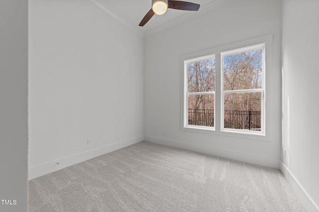 empty room with light carpet, ceiling fan, and crown molding