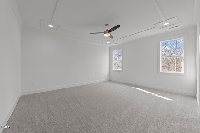 empty room with carpet, crown molding, and plenty of natural light