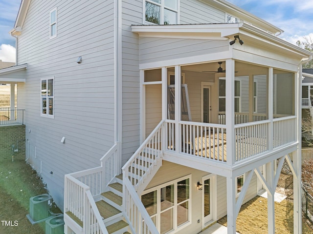 view of side of property with a sunroom and central air condition unit