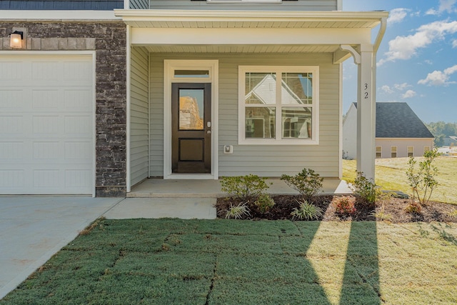 entrance to property with a yard and a garage