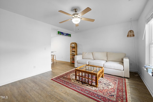 living room with dark hardwood / wood-style floors and ceiling fan