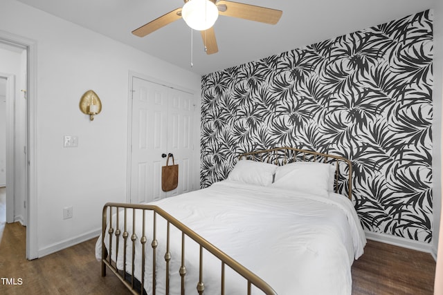 bedroom featuring dark hardwood / wood-style flooring, a closet, and ceiling fan