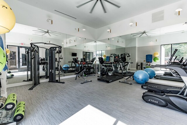 workout area with ceiling fan and light colored carpet