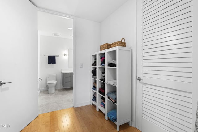 bathroom with vanity, hardwood / wood-style flooring, and toilet