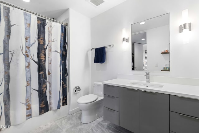 bathroom featuring vanity and toilet