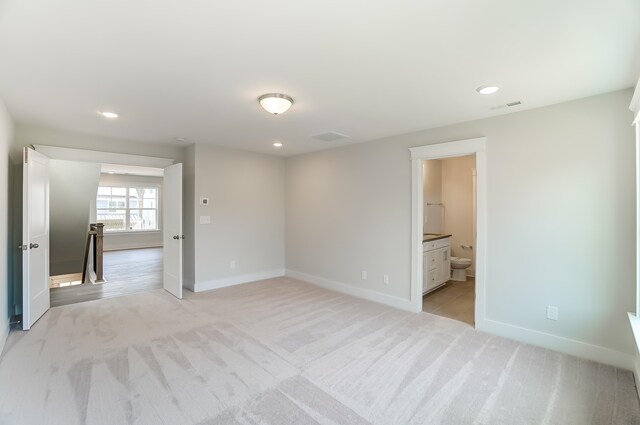 2023 Seneca Dr Lot 32, Raleigh, NC 27604 - unfurnished bedroom with ensuite bath and light colored carpet