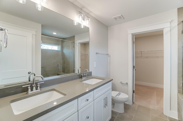 2023 Seneca Dr Lot 32, Raleigh, NC 27604 - bathroom with tile flooring, double sink, a shower with shower door, oversized vanity, and toilet