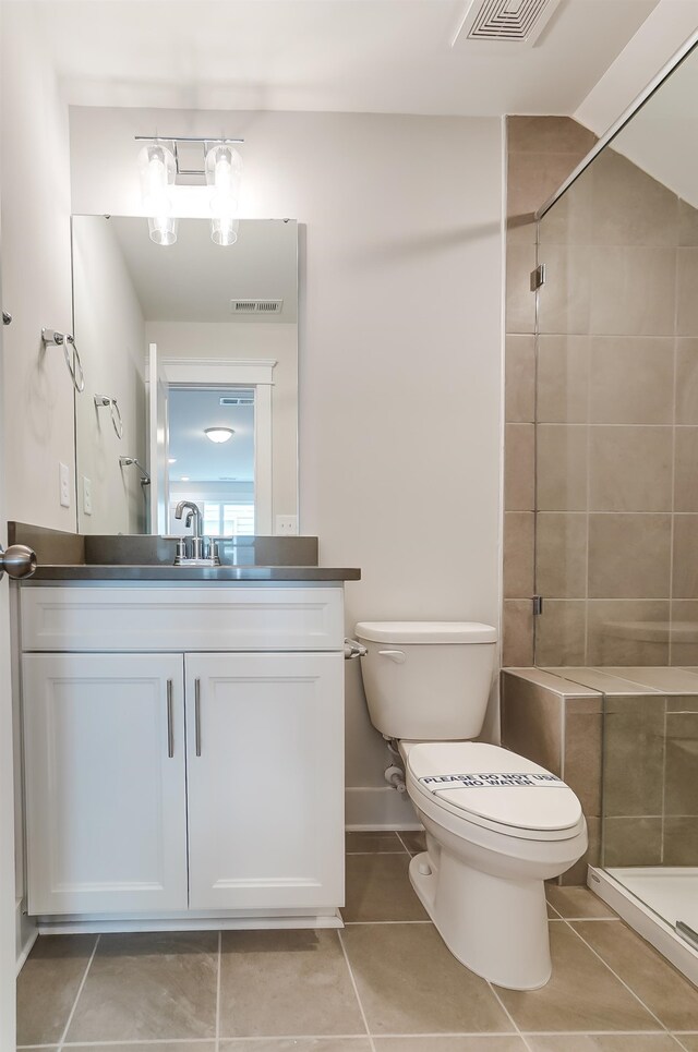 2023 Seneca Dr Lot 32, Raleigh, NC 27604 - bathroom featuring a tile shower, tile flooring, vanity, and toilet