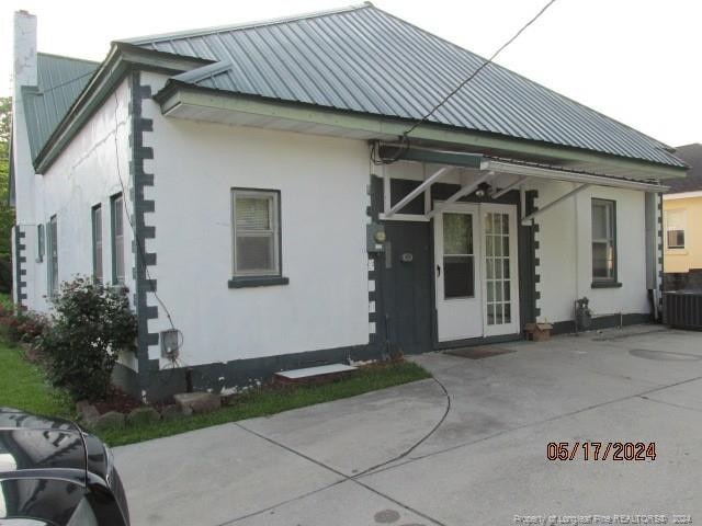 rear view of house with central AC unit