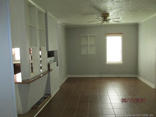 607 Carthage Rd, Lumberton, NC 28358 - spare room featuring ceiling fan, tile flooring, and a textured ceiling