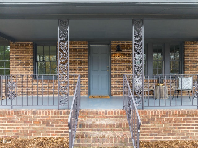 entrance to property featuring covered porch