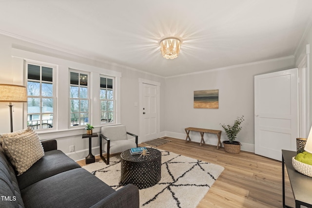 living room featuring light hardwood / wood-style flooring and crown molding