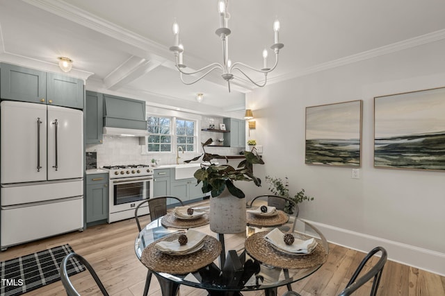 kitchen featuring decorative backsplash, high quality appliances, crown molding, and light wood-type flooring