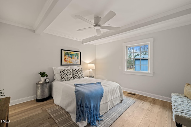 bedroom with beam ceiling, light hardwood / wood-style floors, ceiling fan, and crown molding