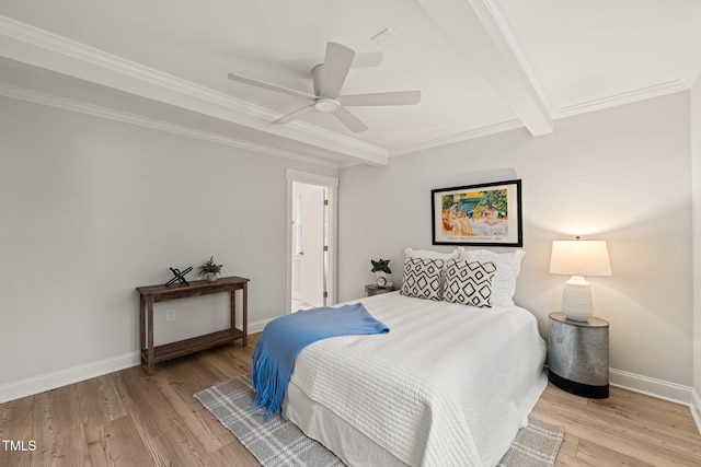 bedroom with light wood-type flooring, ensuite bathroom, ceiling fan, crown molding, and beam ceiling