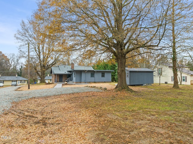 view of front of home featuring a storage unit