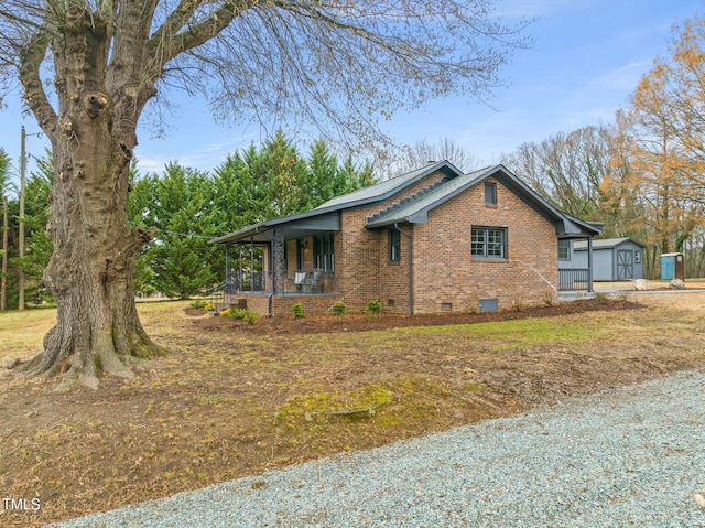 view of home's exterior featuring a porch, a garage, and an outdoor structure