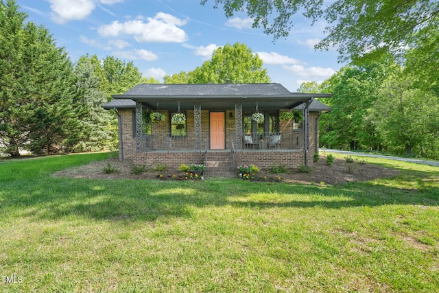 view of front facade featuring brick siding, a porch, and a front lawn