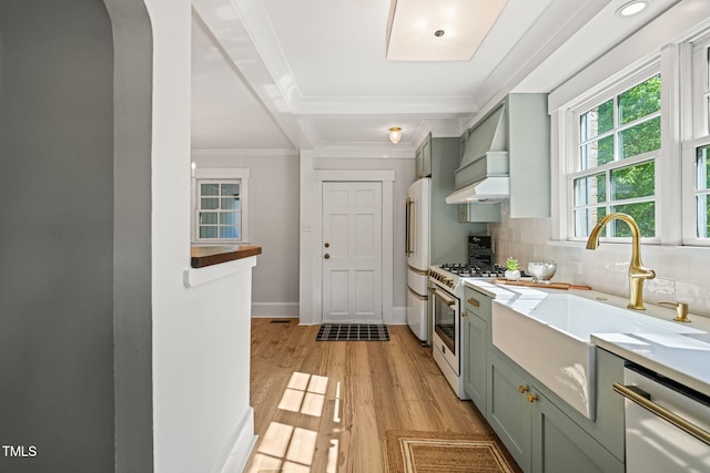 kitchen with dishwasher, premium range hood, arched walkways, green cabinets, and white range with gas cooktop