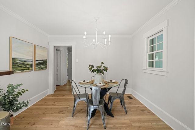 dining space with an inviting chandelier, visible vents, crown molding, baseboards, and light wood-style flooring