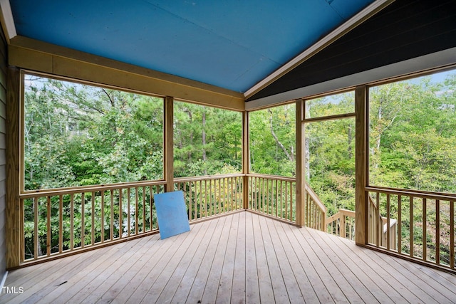 unfurnished sunroom featuring lofted ceiling