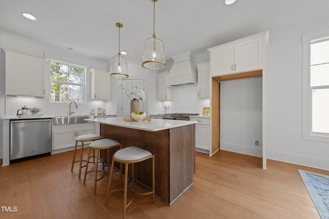 kitchen with white cabinetry, sink, dishwasher, a center island, and custom exhaust hood