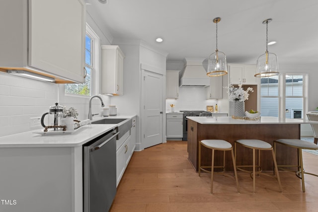 kitchen with custom exhaust hood, a center island, backsplash, white cabinets, and stainless steel appliances