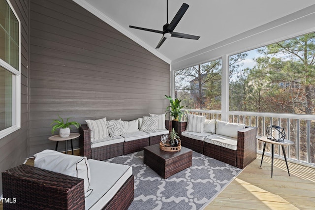 sunroom / solarium featuring ceiling fan and vaulted ceiling