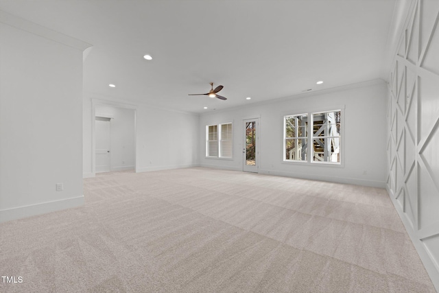 carpeted empty room with ceiling fan and ornamental molding