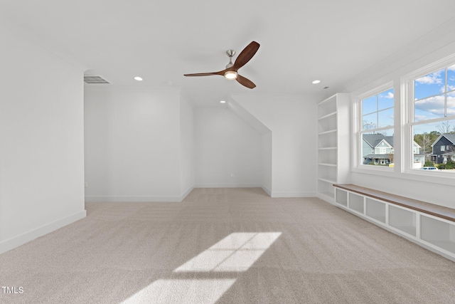 bonus room featuring light carpet and ceiling fan