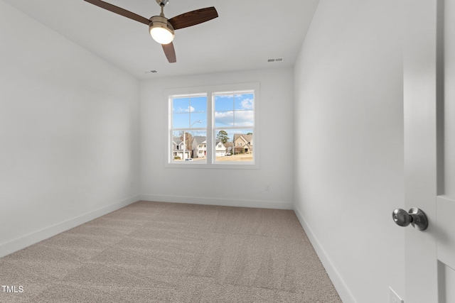 spare room featuring ceiling fan and carpet floors