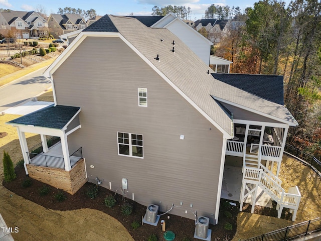 back of property with a balcony and cooling unit