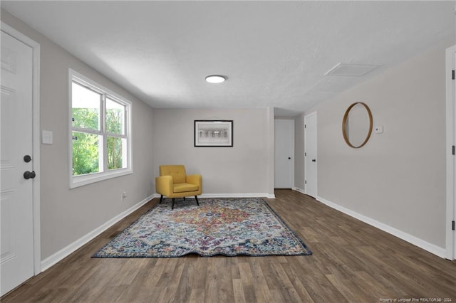 sitting room with dark hardwood / wood-style flooring