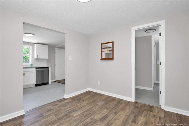 carpeted empty room featuring a textured ceiling