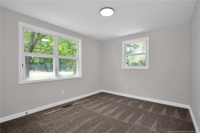 carpeted empty room with a wealth of natural light