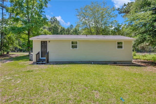 rear view of house with a lawn