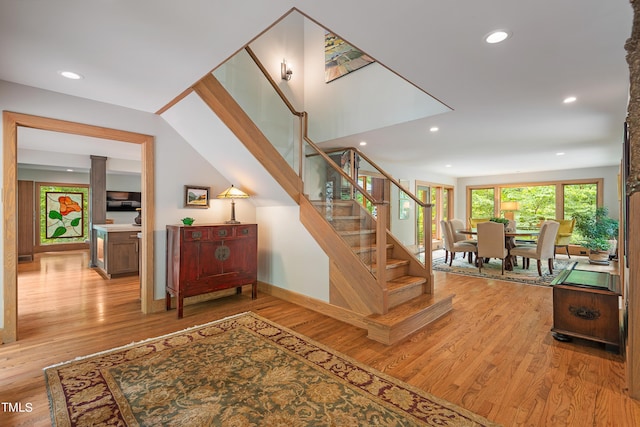 stairway with hardwood / wood-style flooring