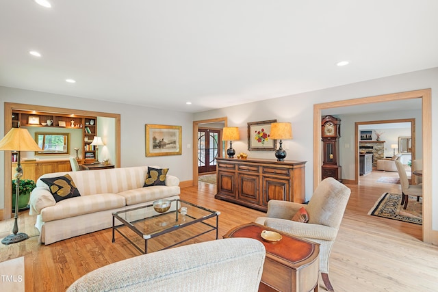 living room featuring plenty of natural light, a fireplace, and light wood-type flooring