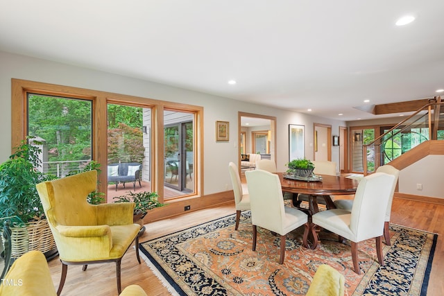 dining space with plenty of natural light and light hardwood / wood-style flooring