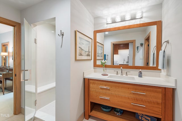 bathroom featuring vanity and a shower with door