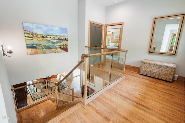 hallway with hardwood / wood-style flooring