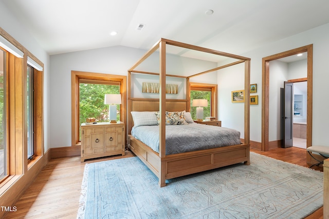 bedroom featuring vaulted ceiling and light wood-type flooring