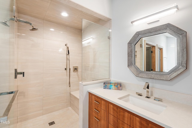 bathroom with vanity and tiled shower